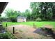 Spacious backyard featuring a brick patio, shed, wooden fence, and mature trees, perfect for outdoor activities at 6601 Twin Brooks Dr, Indianapolis, IN 46227
