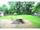 Backyard with large grassy area and brick patio at 6601 Twin Brooks Dr, Indianapolis, IN 46227