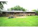 Backyard with grassy area and wooden patio at 6601 Twin Brooks Dr, Indianapolis, IN 46227