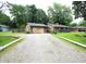 Single-story home with a gravel driveway and a detached garage at 6601 Twin Brooks Dr, Indianapolis, IN 46227