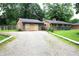 Single-story home with a gravel driveway and a detached garage at 6601 Twin Brooks Dr, Indianapolis, IN 46227