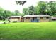Charming single-story home with a well-manicured lawn and a cozy blue front porch at 6601 Twin Brooks Dr, Indianapolis, IN 46227