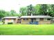 Charming single-story home with a well-manicured lawn and a cozy blue front porch at 6601 Twin Brooks Dr, Indianapolis, IN 46227