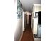 Hallway with wood floors, white walls, and view to the fireplace with mantle at 6601 Twin Brooks Dr, Indianapolis, IN 46227