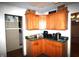 Kitchen features wood cabinetry, green countertops, tile floors and views to other areas of the home at 6601 Twin Brooks Dr, Indianapolis, IN 46227