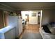 The living room has a sofa, refrigerator, and access to other rooms at 6601 Twin Brooks Dr, Indianapolis, IN 46227