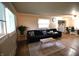Inviting living room with hardwood floors, two sofas, and ample natural light from the window at 6601 Twin Brooks Dr, Indianapolis, IN 46227