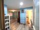 Open living area with wood-look floors, and light-blue walls that leads to other areas of the home at 6601 Twin Brooks Dr, Indianapolis, IN 46227