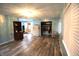 Living room showcasing light blue walls, wood-look floors, and a closet with clothes at 6601 Twin Brooks Dr, Indianapolis, IN 46227