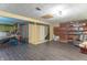Spacious basement area with weight training set up, neutral paint, tile floor and storage at 6837 Littleton Dr, Indianapolis, IN 46221
