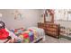Bright bedroom with a wooden dresser, and decor on the wall at 6837 Littleton Dr, Indianapolis, IN 46221