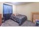 A bedroom features neutral walls, a bed with pillows, and a dark curtain at 6837 Littleton Dr, Indianapolis, IN 46221