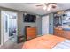 Primary bedroom with television, closet, and bathroom at 6837 Littleton Dr, Indianapolis, IN 46221