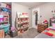 Cozy bedroom featuring a dollhouse, closet, and gray carpeting at 6837 Littleton Dr, Indianapolis, IN 46221