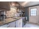 Kitchen sink features stainless steel appliances and a tiled backsplash at 6837 Littleton Dr, Indianapolis, IN 46221