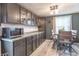Eat-in kitchen features ample cabinets, a microwave, and a window for natural light at 6837 Littleton Dr, Indianapolis, IN 46221