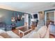 Spacious living room featuring hardwood floors, a comfortable sofa, and entertainment area at 6837 Littleton Dr, Indianapolis, IN 46221