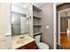 Bathroom featuring wood vanity, open shelving, and a toilet at 706 University Blvd, Anderson, IN 46012