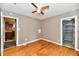 Bedroom with hardwood floors, ceiling fan, and access to a walk-in closet at 706 University Blvd, Anderson, IN 46012