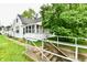 Exterior shot of a home with a screened porch, white railings and green trees at 706 University Blvd, Anderson, IN 46012