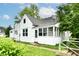 Charming home featuring classic architecture, landscaped greenery, and a welcoming enclosed porch at 706 University Blvd, Anderson, IN 46012