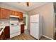 Functional kitchen with white appliances and warm wood cabinets at 706 University Blvd, Anderson, IN 46012