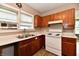Cozy kitchen featuring wood cabinets and a stainless steel sink at 706 University Blvd, Anderson, IN 46012