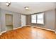 Bright living room with hardwood floors, neutral paint, and a large window at 706 University Blvd, Anderson, IN 46012