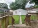 View of the backyard features a large garage with a walking path and wooden fence at 730 N Riley Ave, Indianapolis, IN 46201