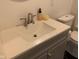 Bathroom vanity features a white countertop, stylish faucet, and soap dispenser with convenient toilet at 730 N Riley Ave, Indianapolis, IN 46201