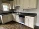 Well-lit kitchen equipped with stainless steel appliances, wood cabinets, and dark countertops at 730 N Riley Ave, Indianapolis, IN 46201