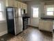 Kitchen boasts stainless steel appliances, wood cabinets, and a rear door for easy access at 730 N Riley Ave, Indianapolis, IN 46201