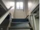 Basement stairwell leads to a door with lots of natural light at 730 N Riley Ave, Indianapolis, IN 46201