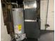 Basement area featuring a water heater, furnace, and exposed brick at 730 N Riley Ave, Indianapolis, IN 46201