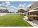 Expansive lawn with a covered patio, outdoor dining, and a fenced perimeter at 750 Trillium St, Lebanon, IN 46052