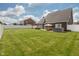 Spacious backyard with a white fence, patio, outdoor dining area, and hot tub at 750 Trillium St, Lebanon, IN 46052
