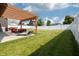 Landscaped backyard with a pergola, lounge chairs, and stylish outdoor seating; great for entertaining at 750 Trillium St, Lebanon, IN 46052