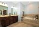 This primary bathroom features a double sink vanity and a soaking tub with decorative tile surround at 750 Trillium St, Lebanon, IN 46052