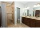 A bathroom with double sink vanity, tiled shower with bench, and neutral-toned walls and flooring at 750 Trillium St, Lebanon, IN 46052