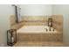 A well-lit soaking tub with decorative tile surround and modern fixtures creates a relaxing retreat at 750 Trillium St, Lebanon, IN 46052