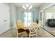 Dining room with natural light, a decorative chandelier, and sliding doors leading to the sunroom at 750 Trillium St, Lebanon, IN 46052