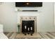 Close-up of the fireplace featuring a white mantle and decorative tile surround at 750 Trillium St, Lebanon, IN 46052