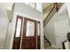 Grand foyer featuring a dark wood door and staircase at 750 Trillium St, Lebanon, IN 46052