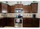 Well-appointed kitchen featuring stainless steel appliances and dark wood cabinets at 750 Trillium St, Lebanon, IN 46052