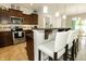 Eat-in kitchen with breakfast bar and stainless steel appliances and dark cabinets at 750 Trillium St, Lebanon, IN 46052