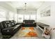 Inviting living room with a decorative rug, plush seating, and large windows at 750 Trillium St, Lebanon, IN 46052
