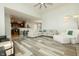 Open-concept living area with gray wood floors and kitchen access at 750 Trillium St, Lebanon, IN 46052