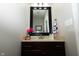 The powder room has a dark wood vanity with a decorative mirror and neutral walls at 750 Trillium St, Lebanon, IN 46052