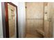 The tiled shower features a built-in niche and a shower bench for added convenience at 750 Trillium St, Lebanon, IN 46052