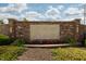 Stone entrance sign for Auburn Meadows, framed by brick and vibrant landscaping at 750 Trillium St, Lebanon, IN 46052